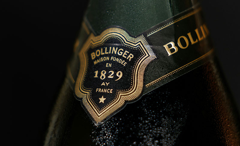 Close-up of a Bollinger champagne bottle neck label showing the 1829 crest