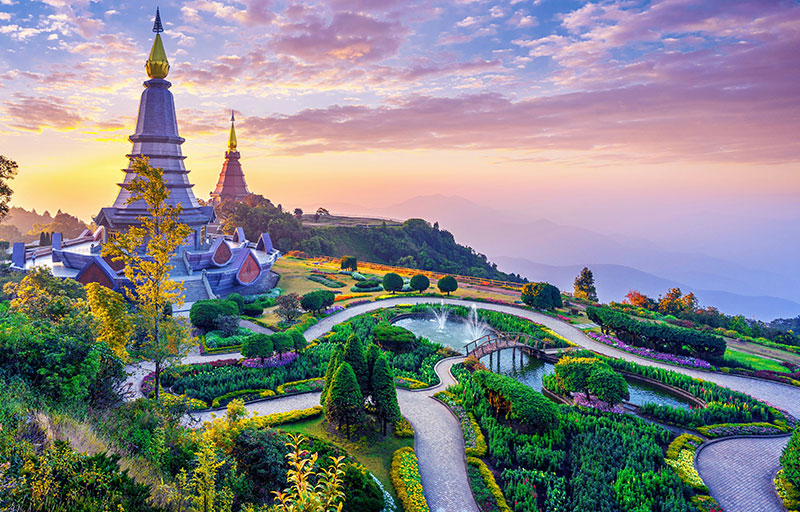 Golden temple stupa in Chiang Mai during the Yi Peng lantern festival at sunset.