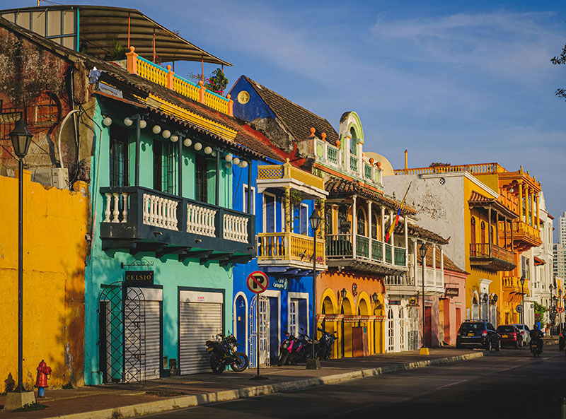 Colorful street with colonial architecture and balconies in Getsemani, Cartagena, Colombia.