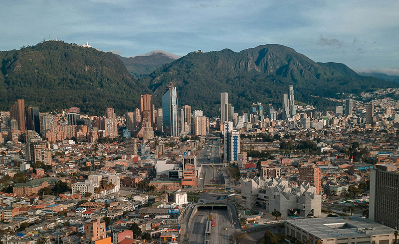 Panoramic view of Bogota, Colombia, nestled in the Andes mountains, with modern buildings and historic Teusaquillo district.