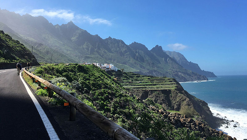 Dramatic coastline of Taganana in the Canary Islands, Spain, with rugged green mountains and a village by the sea.