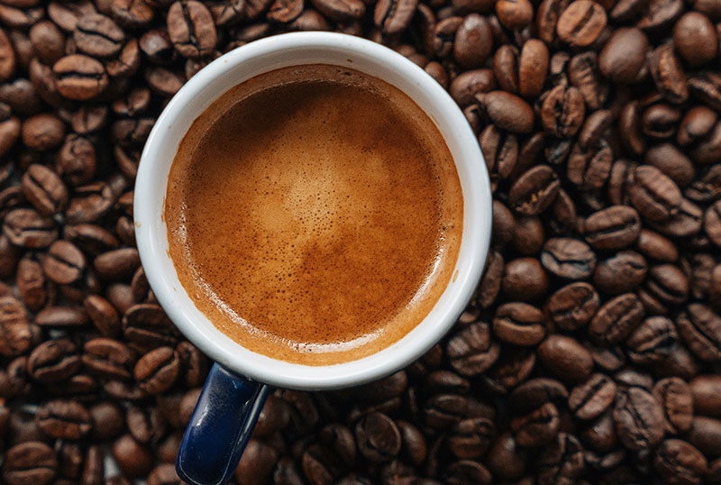 Top-down view of a rich cup of Colombian coffee with foam art.