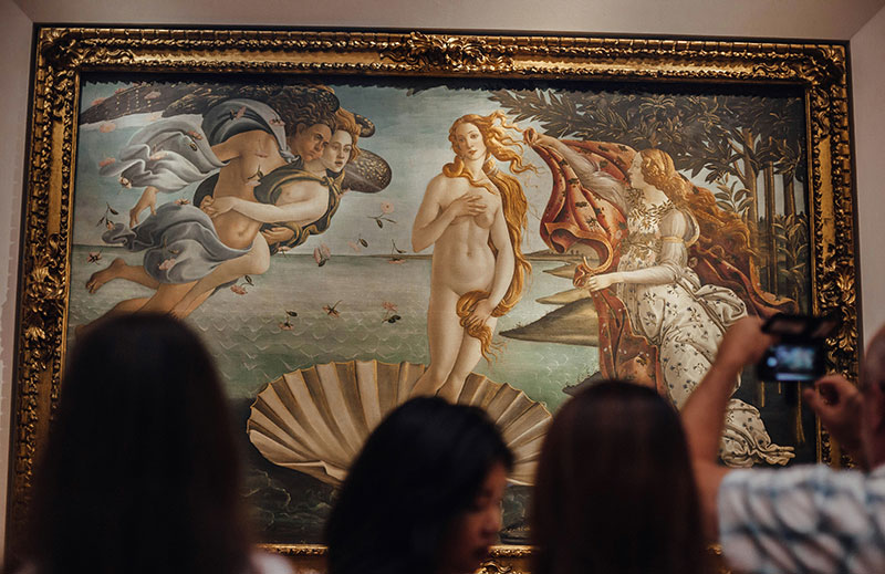 Tourists gathering to view Sandro Botticelli's The Birth of Venus at the Uffizi Gallery in Florence.