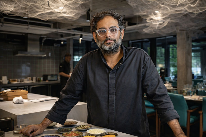 Chef Gaggan Anand standing in the open kitchen at his Bangkok restaurant