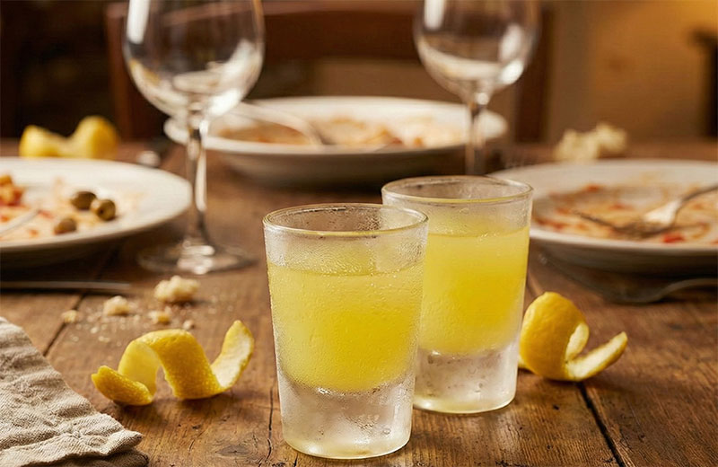 Two frosted glasses of ice-cold Limoncello liqueur.