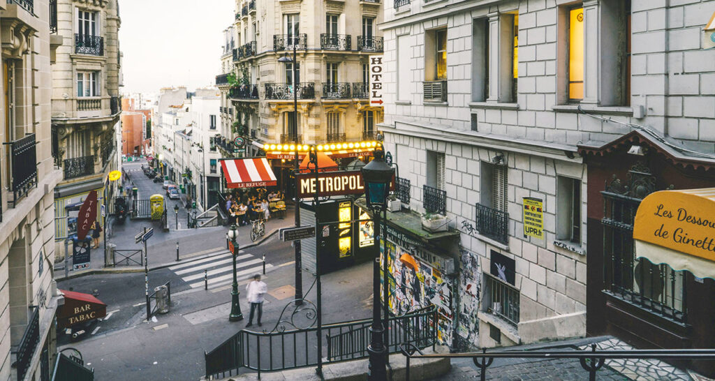 Paris Metro station sign, marking a convenient transit connection in a city neighborhood.