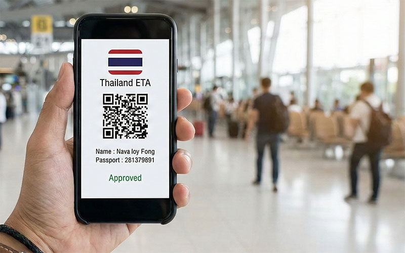 Hand holding a smartphone displaying an approved Thailand ETA digital arrival card with a blurred airport background.