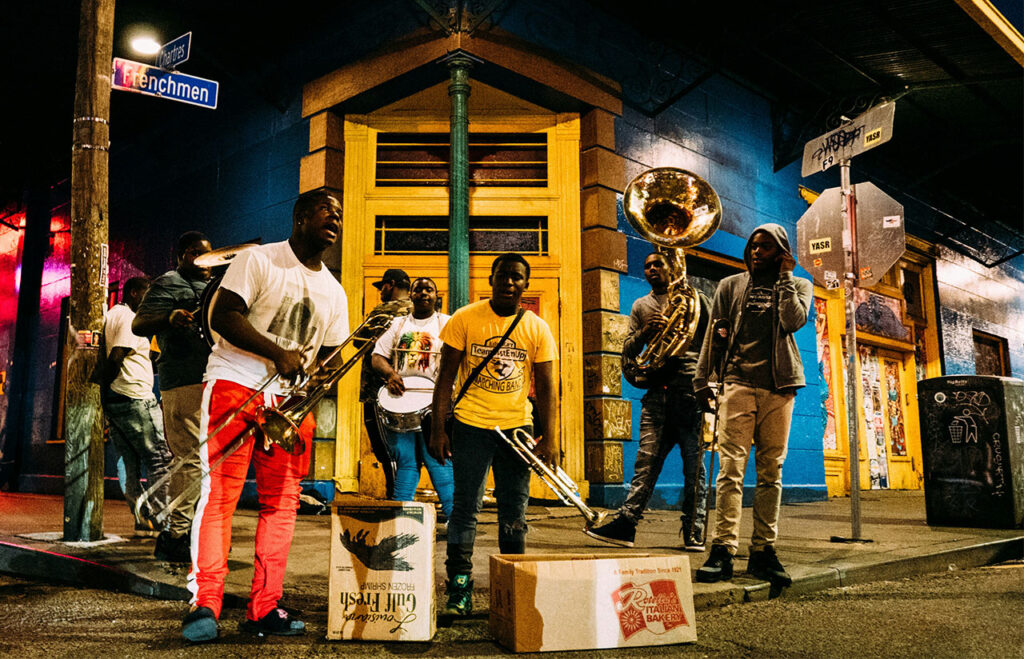 Brass band performing live music on Frenchmen Street at night in New Orleans.