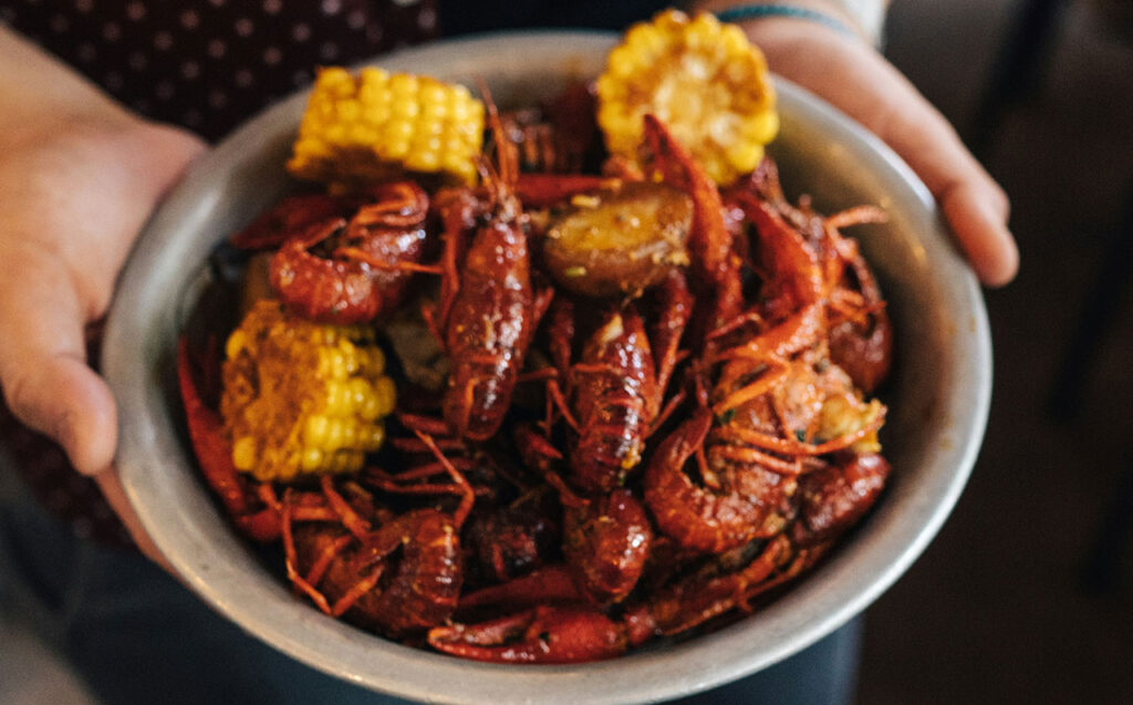 Tray of boiled crawfish, corn, and potatoes