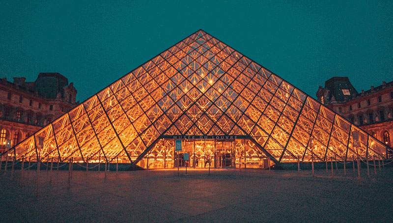 Louvre Museum pyramid at dusk, Paris, France