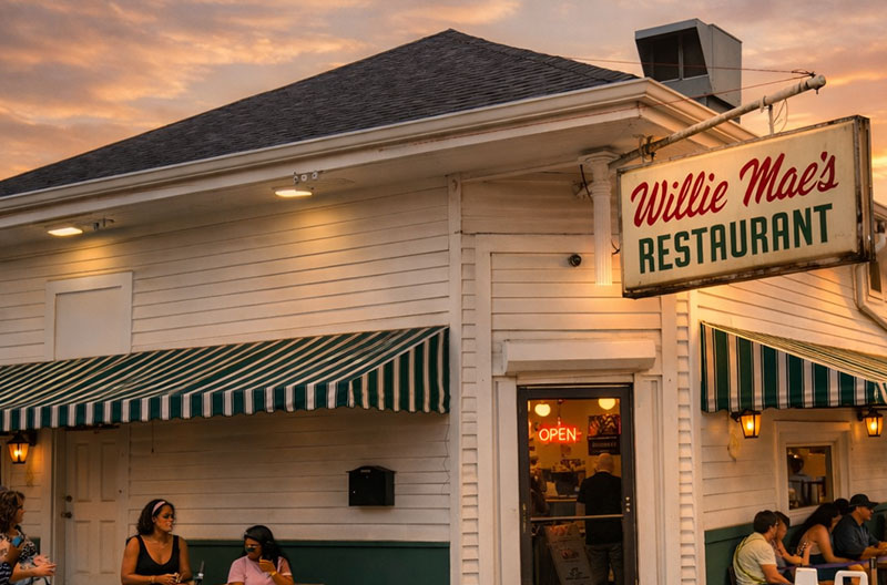 Willie Mae’s Scotch House exterior at golden hour in New Orleans with warm sunset light and outdoor seating