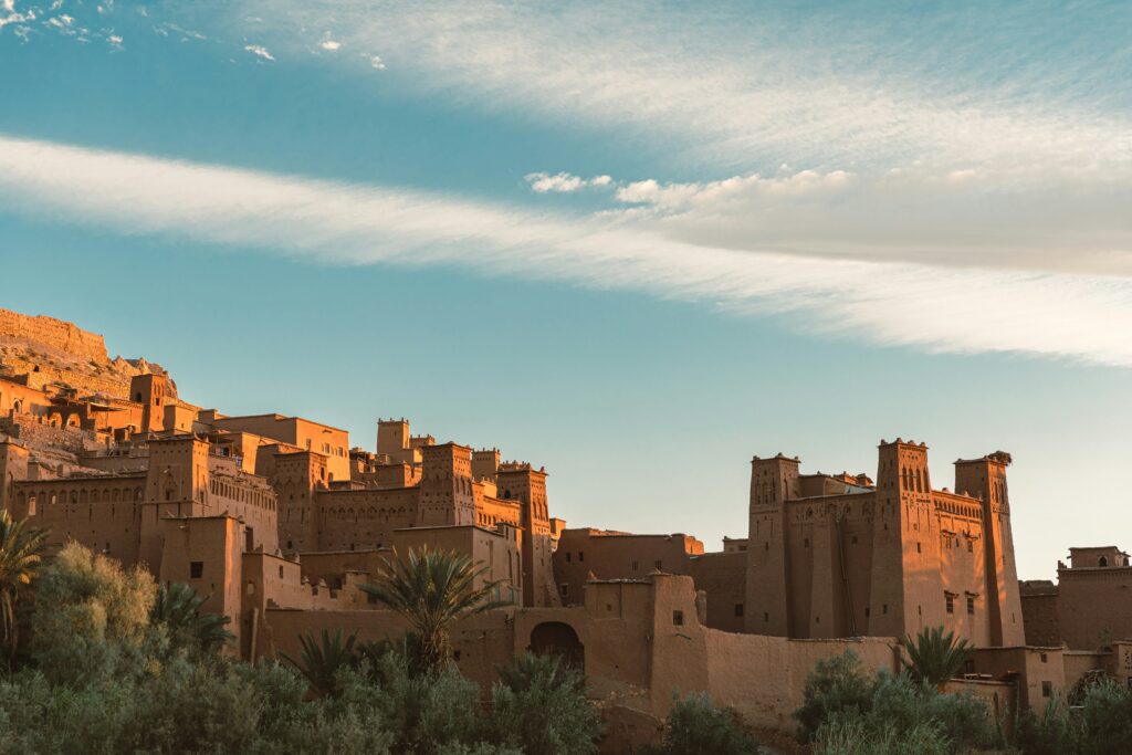 The ancient fortified village of Ait Ben Haddou made of red earthen clay at sunset.