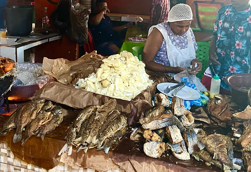 Vendor preparing dried fish and local ingredients at Bazurto Market Cartagena