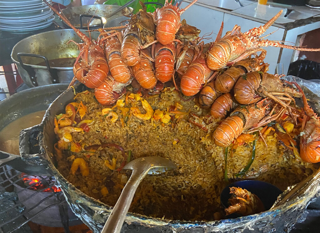 Large pot of rice with lobster and seafood cooking at Bazurto Market Cartagena