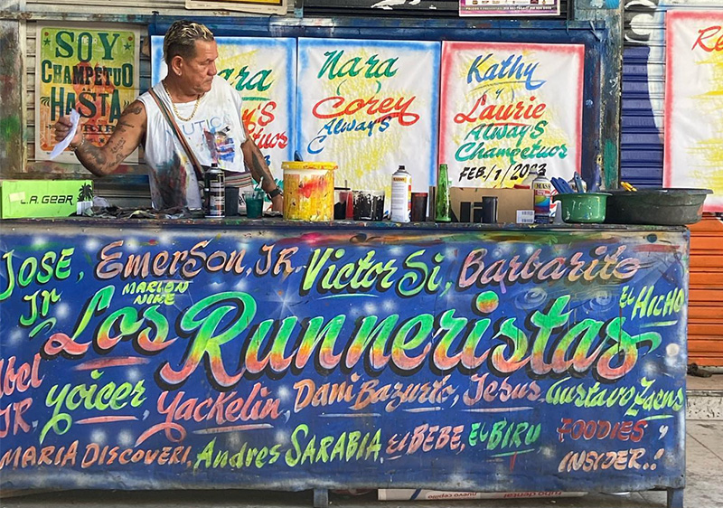Colorful Los Runneristas sign and vendor stall inside Bazurto Market Cartagena