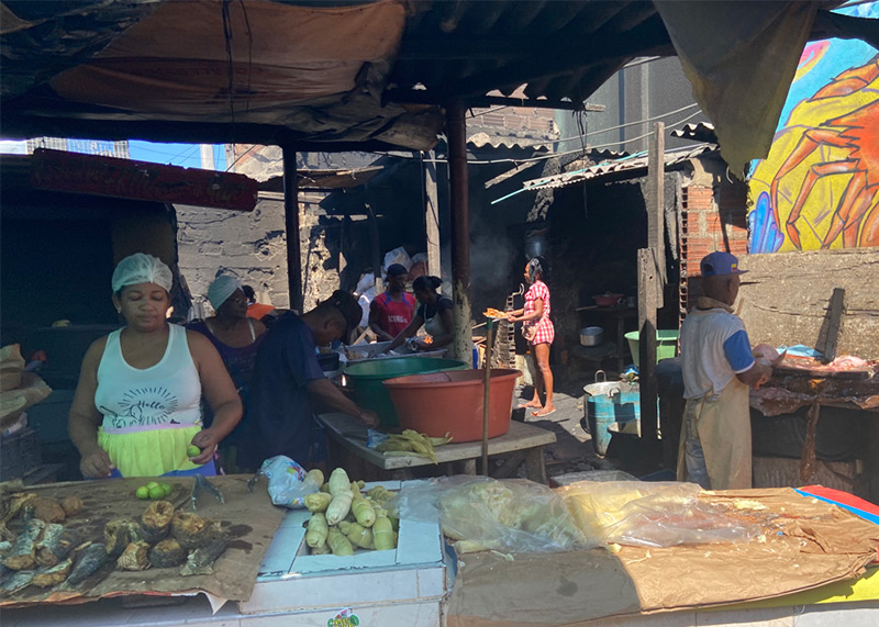 Open-air kitchen with vendors preparing food inside Bazurto Market Cartagena