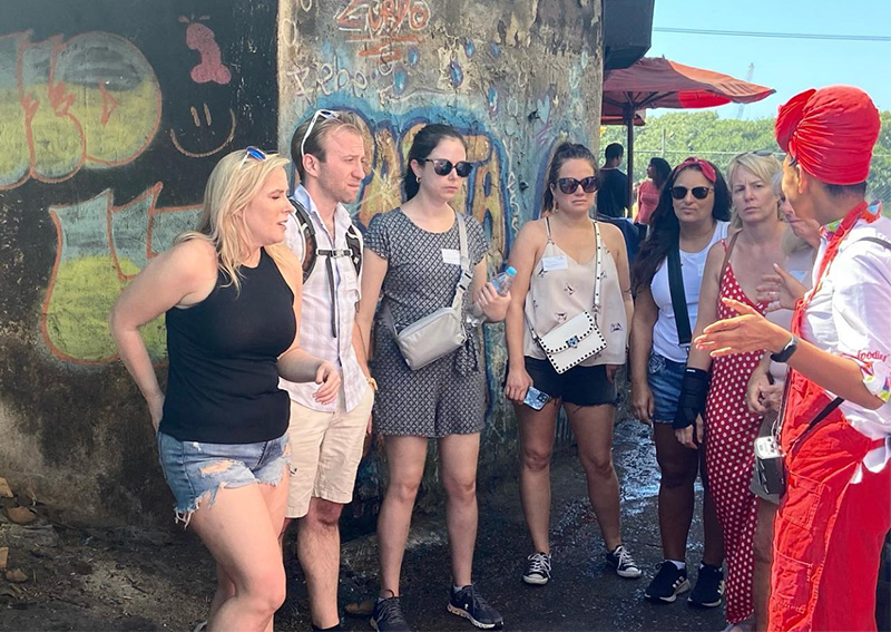 Guided walking tour inside Bazurto Market in Cartagena with local guide and visitors
