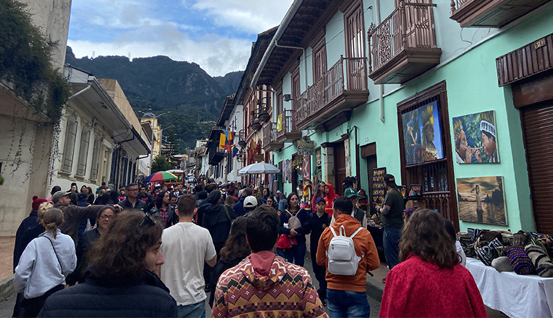 Crowded street scene in Bogotá with locals and tourists