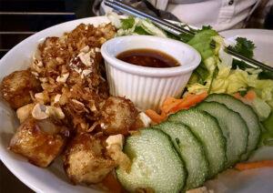 ún Chay Rice Noodle Salad topped with crispy tofu, fresh cucumbers, and crushed peanuts.