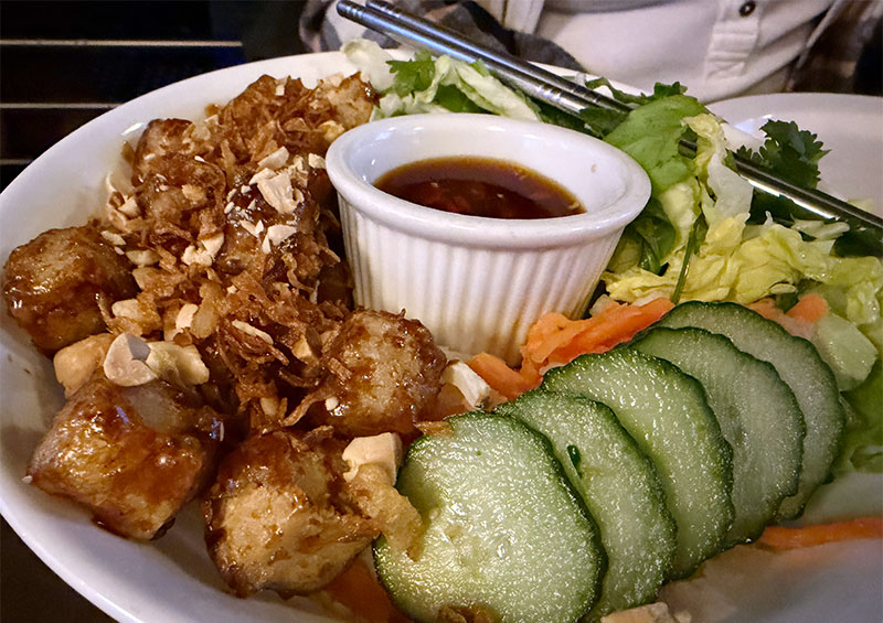 ún Chay Rice Noodle Salad topped with crispy tofu, fresh cucumbers, and crushed peanuts.