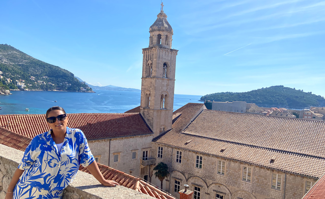 Melissa overlooking Dubrovnik Old Town and the Adriatic Sea while walking the historic city walls in Croatia