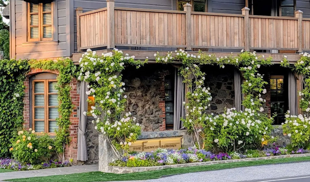 The French Laundry restaurant exterio in Yountville Napa Valley a stone and wood building.