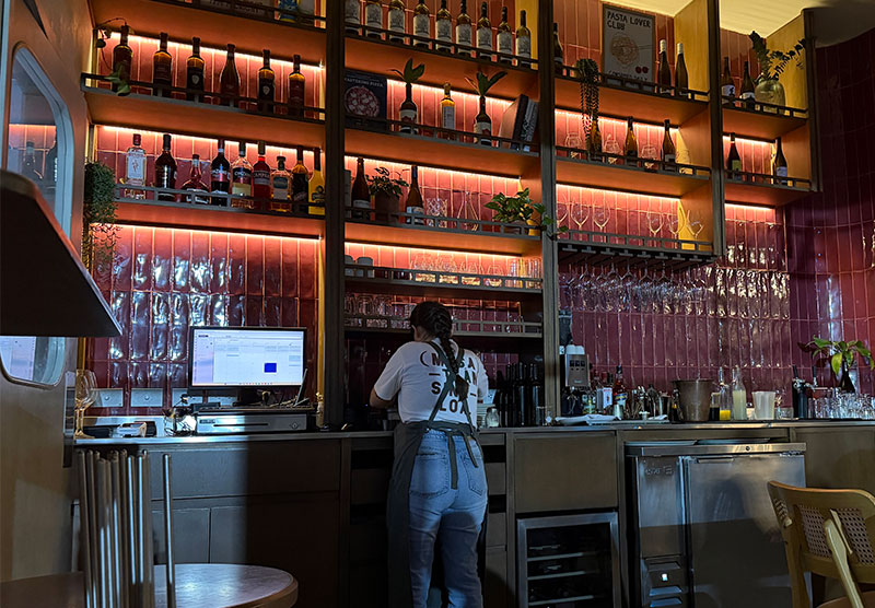 Interior bar and wine shelves at La Sagrada Pizzeria in Mazatlán’s Golden Zone.