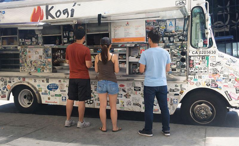 Customers ordering Korean-Mexican street food from the Kogi BBQ food truck in Los Angeles