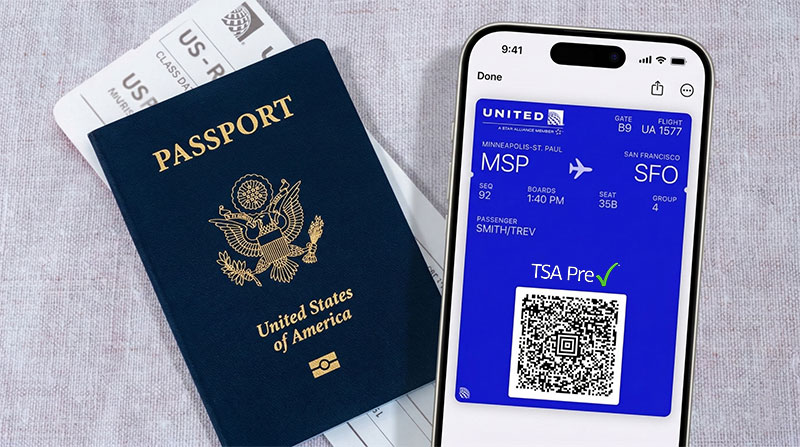 Overhead view of organized travel essentials including a passport, smartphone boarding pass.