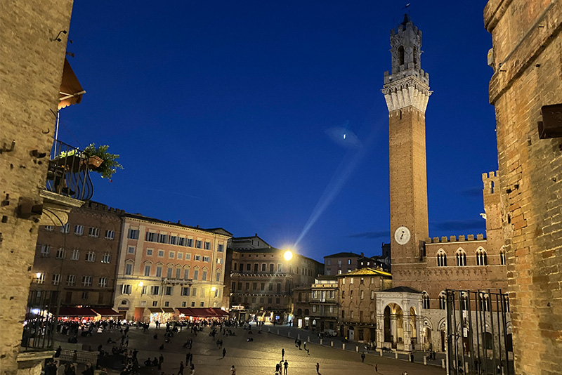 Evening view over Piazza del Campo in Siena with the Torre del Mangia rising above the square