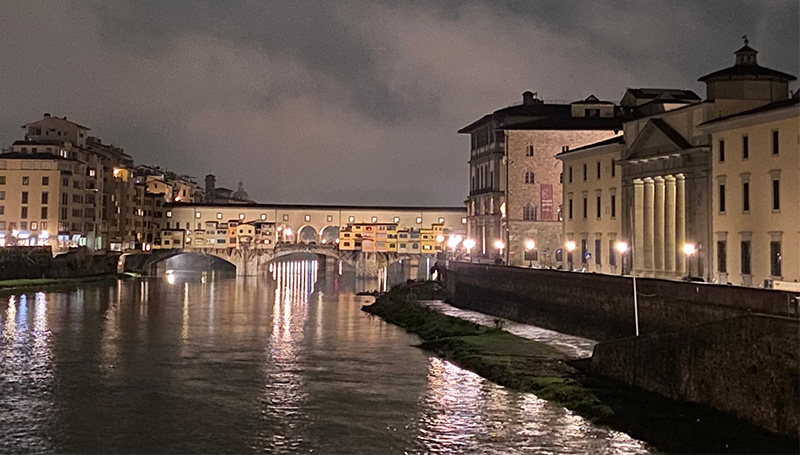 Ponte Vecchio illuminated at night over the Arno River in Florence