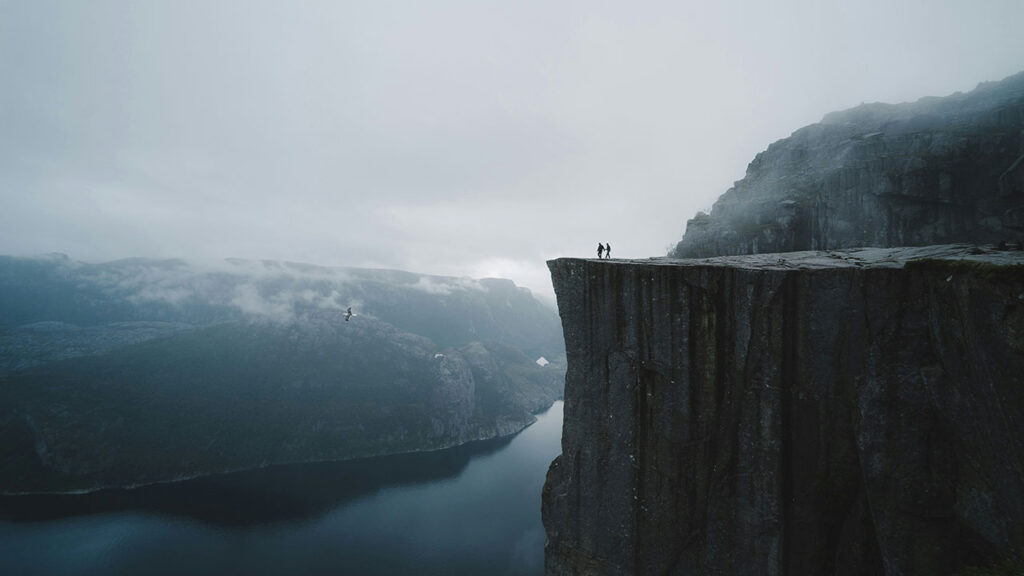 A wide-angle view of the flat-topped Preikestolen cliff towering 604 meters above the Lysefjord in Norway