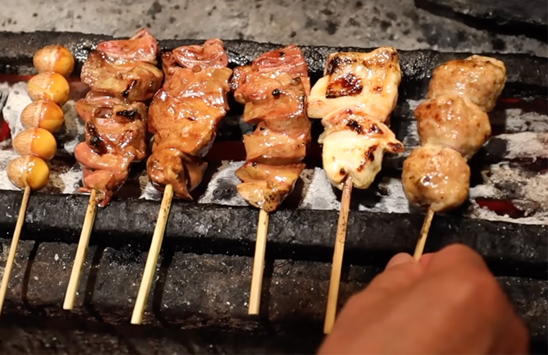 Close up of yakitori meats grilling in Tokyo