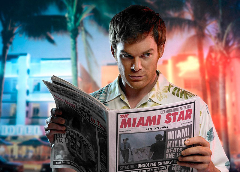 Alt Text: A close-up of the character Dexter Morgan from the TV show "Dexter" sitting outside and reading a newspaper titled "Miami Star" with a headline about a serial killer.
