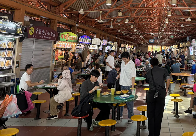 Maxwell Food Centre in Singapore with hawker stalls, diners and rows of food vendors