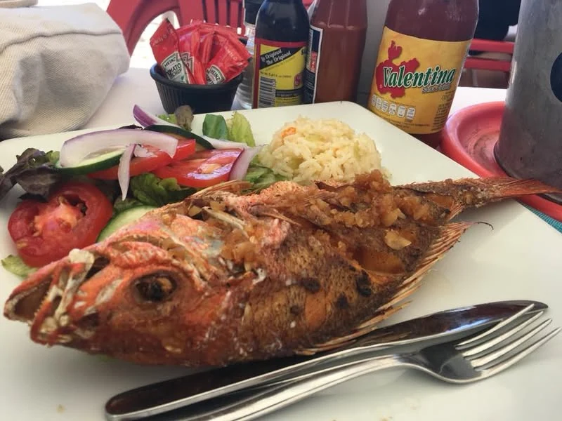Whole fried red snapper with rice and salad at La Langosta Loca in Puerto Vallarta.