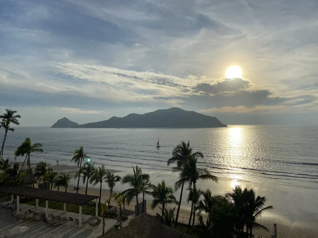 Pacific Ocean and offshore islands seen above palm trees in Mazatlán.