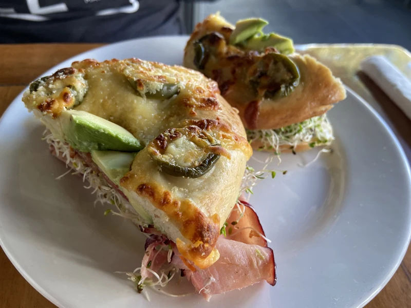 A filled bagel sandwich topped with jalapeño slices at Rico’s Café in Mazatlán.
