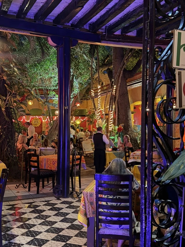 Entrance opening into a colorful courtyard dining area at Topolo in Mazatlán.