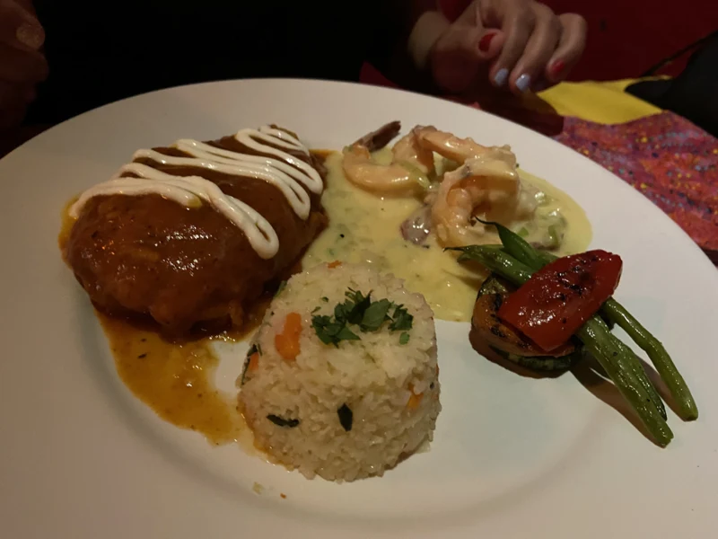 Shrimp with rice, vegetables and sauce on a dinner plate at Topolo in Mazatlán.